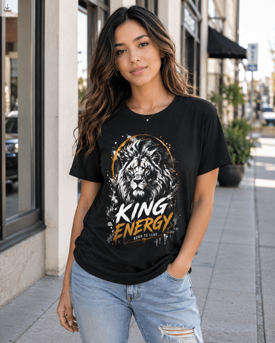 Woman wearing a black t-shirt with a lion graphic and 'King Energy' text on a city street.