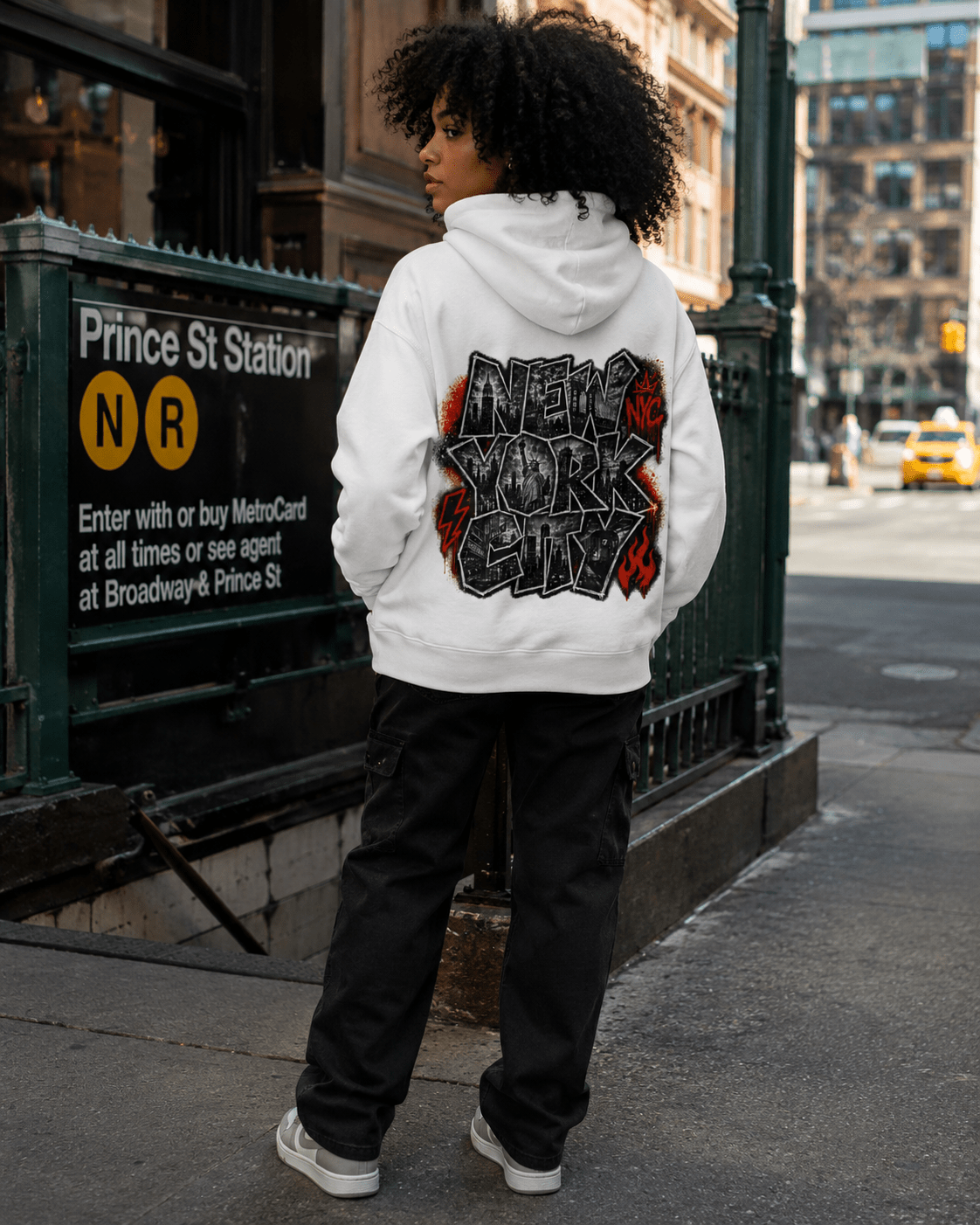 White hoodie worn from back, large NYC graphic on upper back, ribbed cuffs