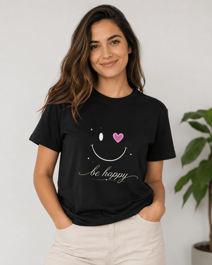Black T-shirt on woman with smiley face graphic, pink heart and 'be happy' lettering