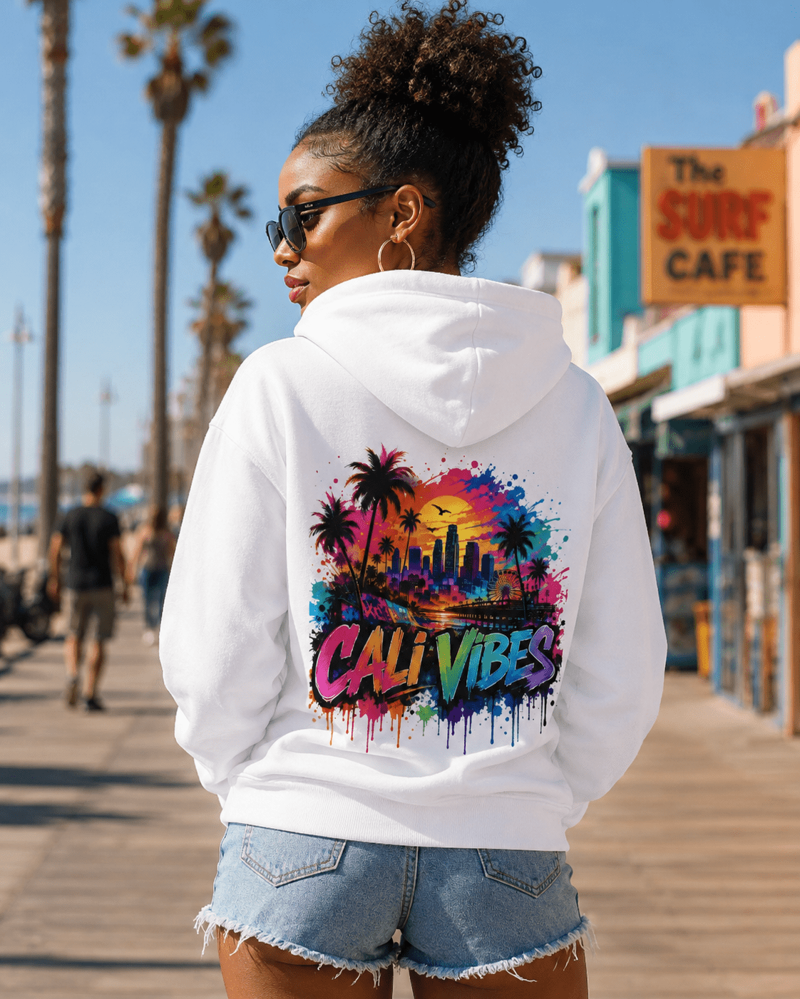 White hoodie worn from the back with “Cali Vibes” city palm print