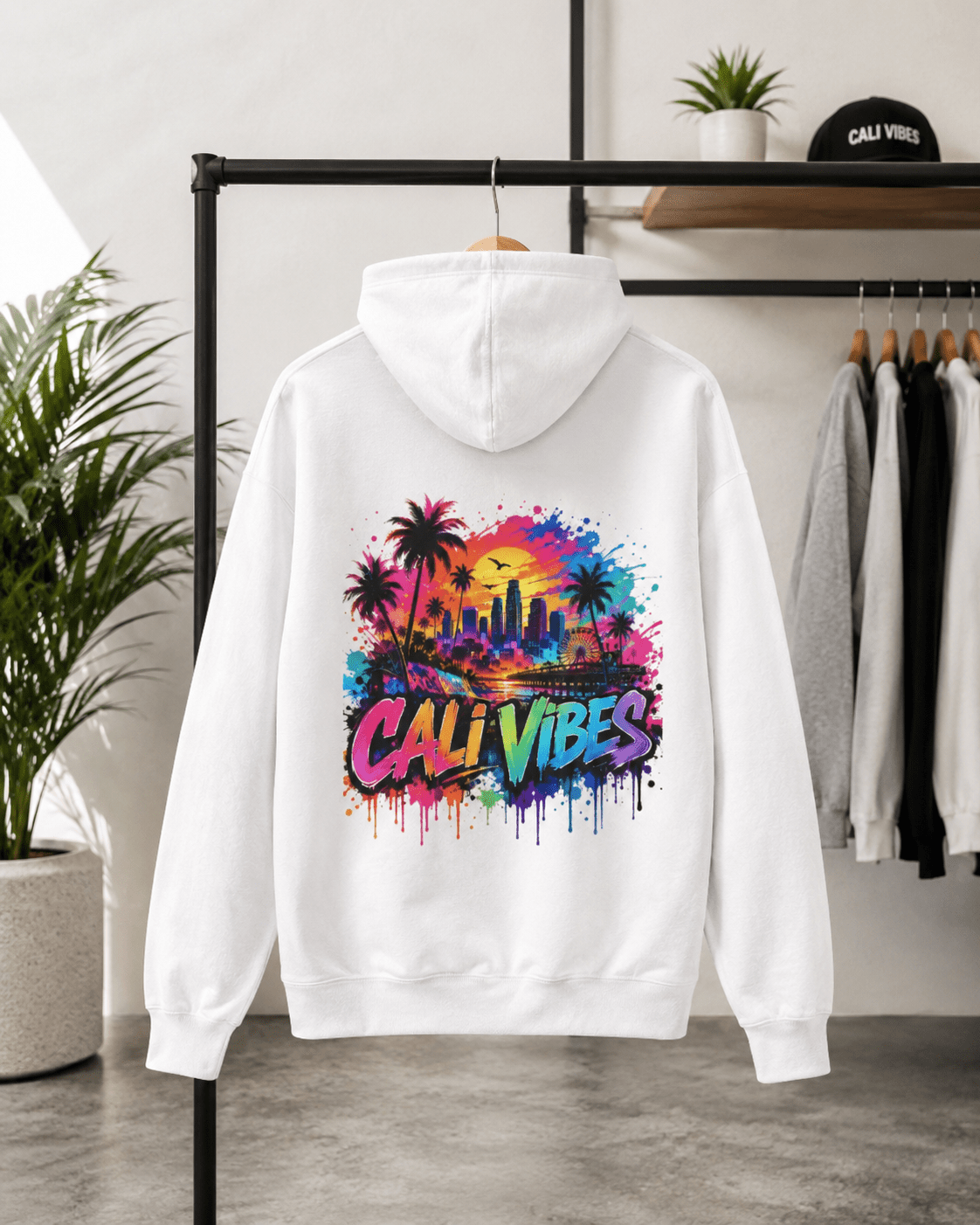 White hoodie with front pocket and multicolor “Cali Vibes” logo graphic