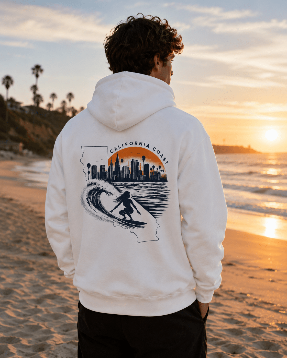 White hoodie worn from behind; California coast surf and city skyline graphic