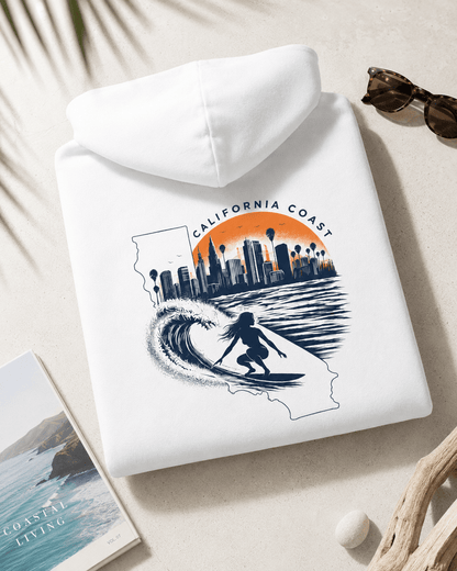 Folded white hoodie with hood; surfboard and city skyline graphic on back