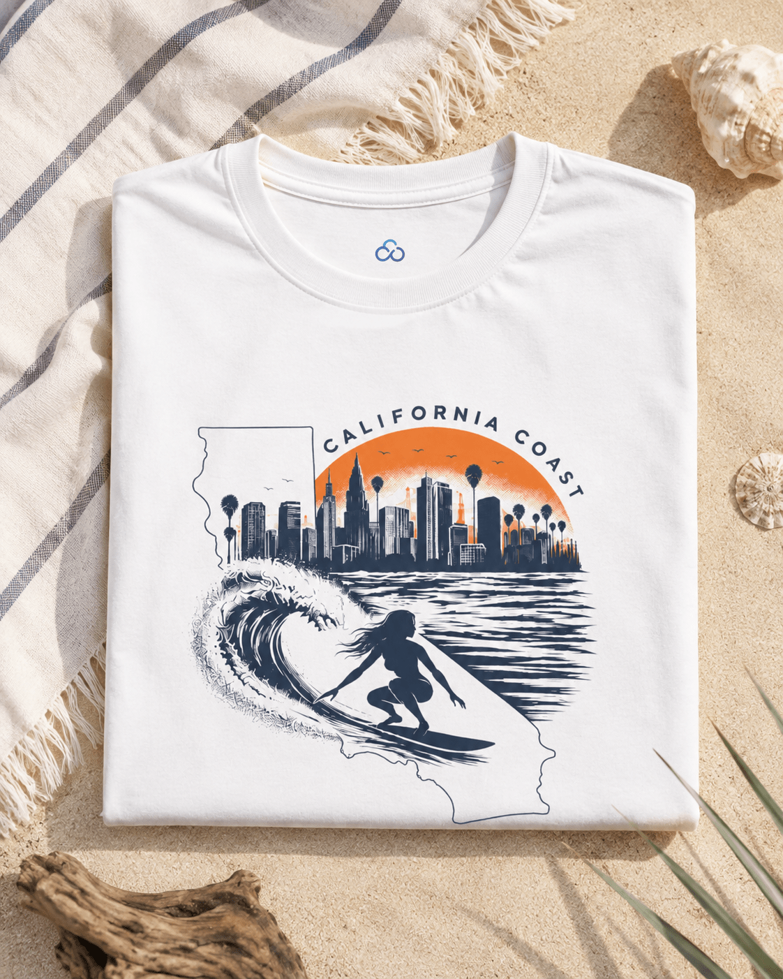 Folded white T-shirt with California coast skyline, wave, and surf silhouette print