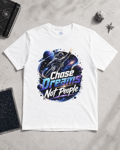 White graphic T-shirt with astronaut, “Chase Dreams Not People” print on chest.
