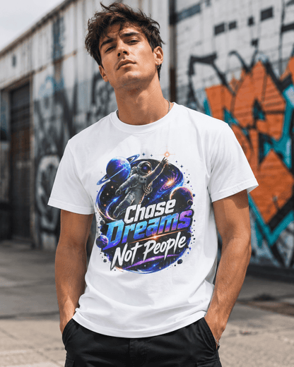 White crewneck T-shirt worn by person, featuring astronaut “Chase Dreams Not People” chest graphic.