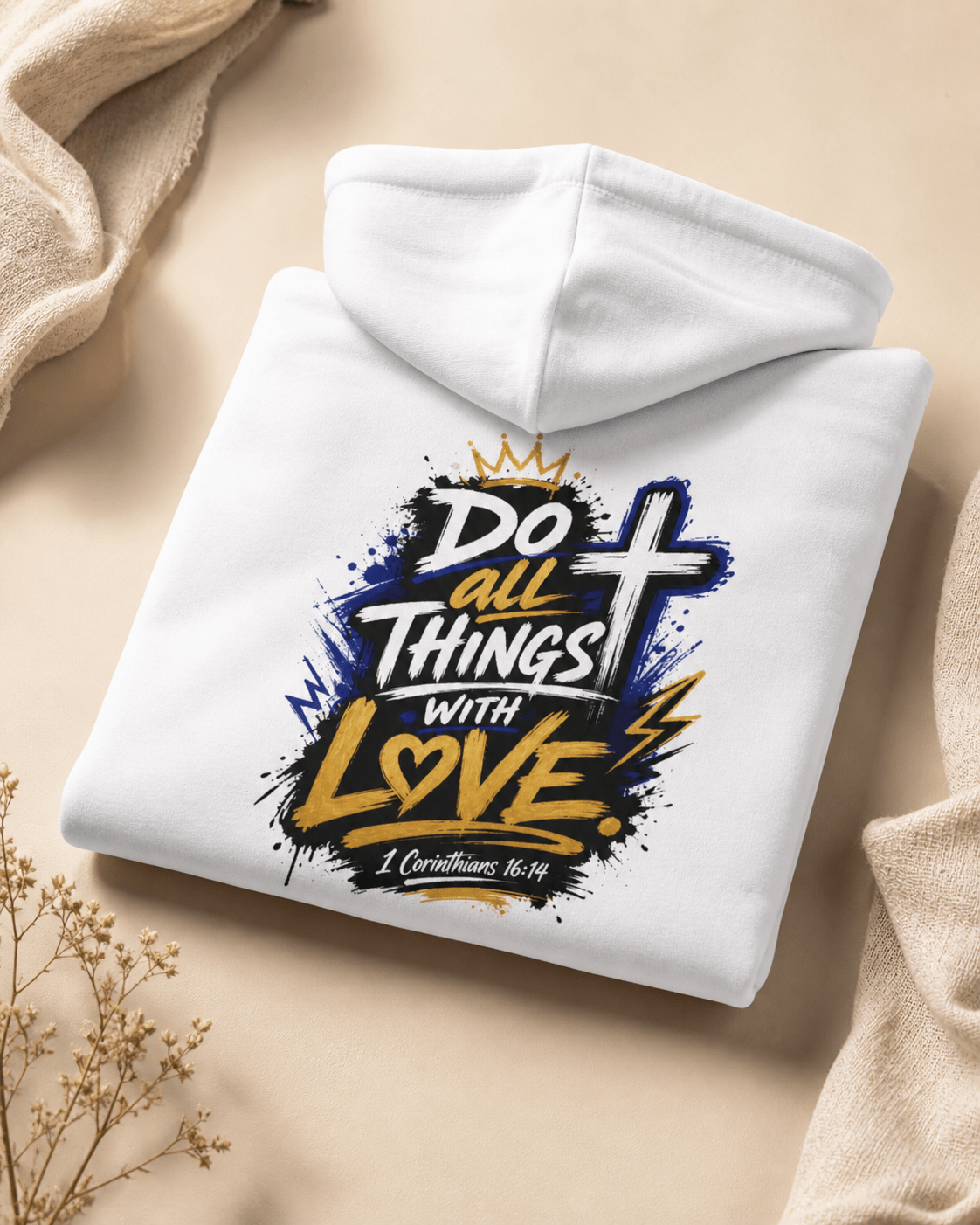 White hoodie laid flat with back print featuring crown, cross, and heart