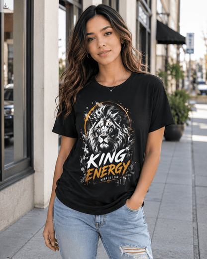 Woman wearing a black t-shirt with a lion graphic and 'King Energy' text on a city street.