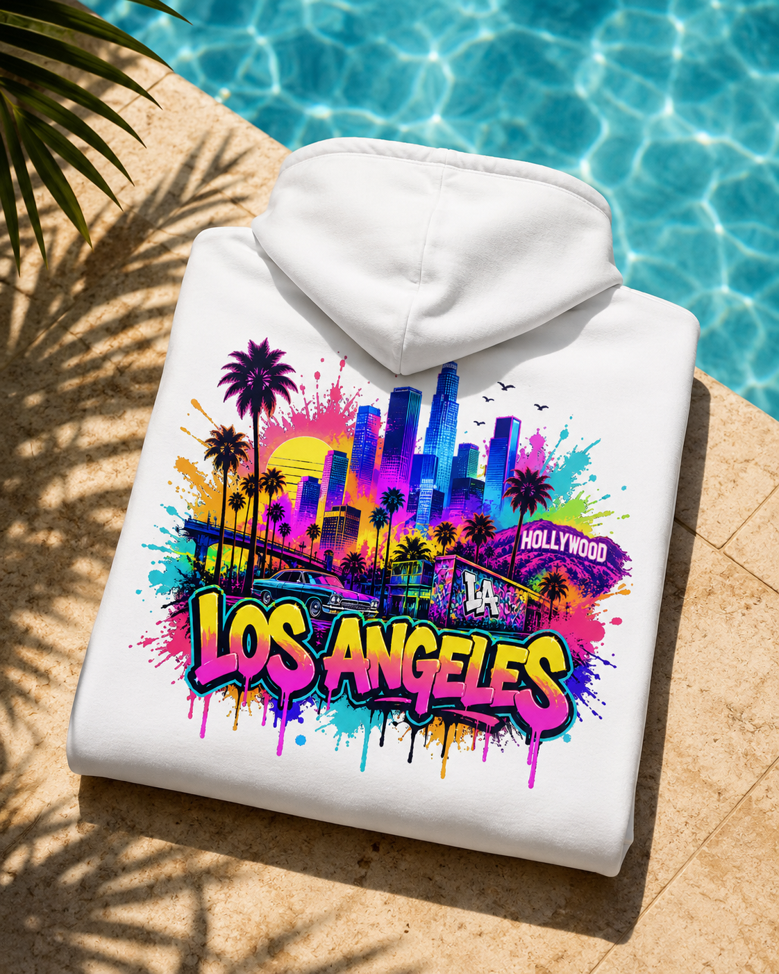Folded white hoodie with colorful graffiti skyline back graphic and hood