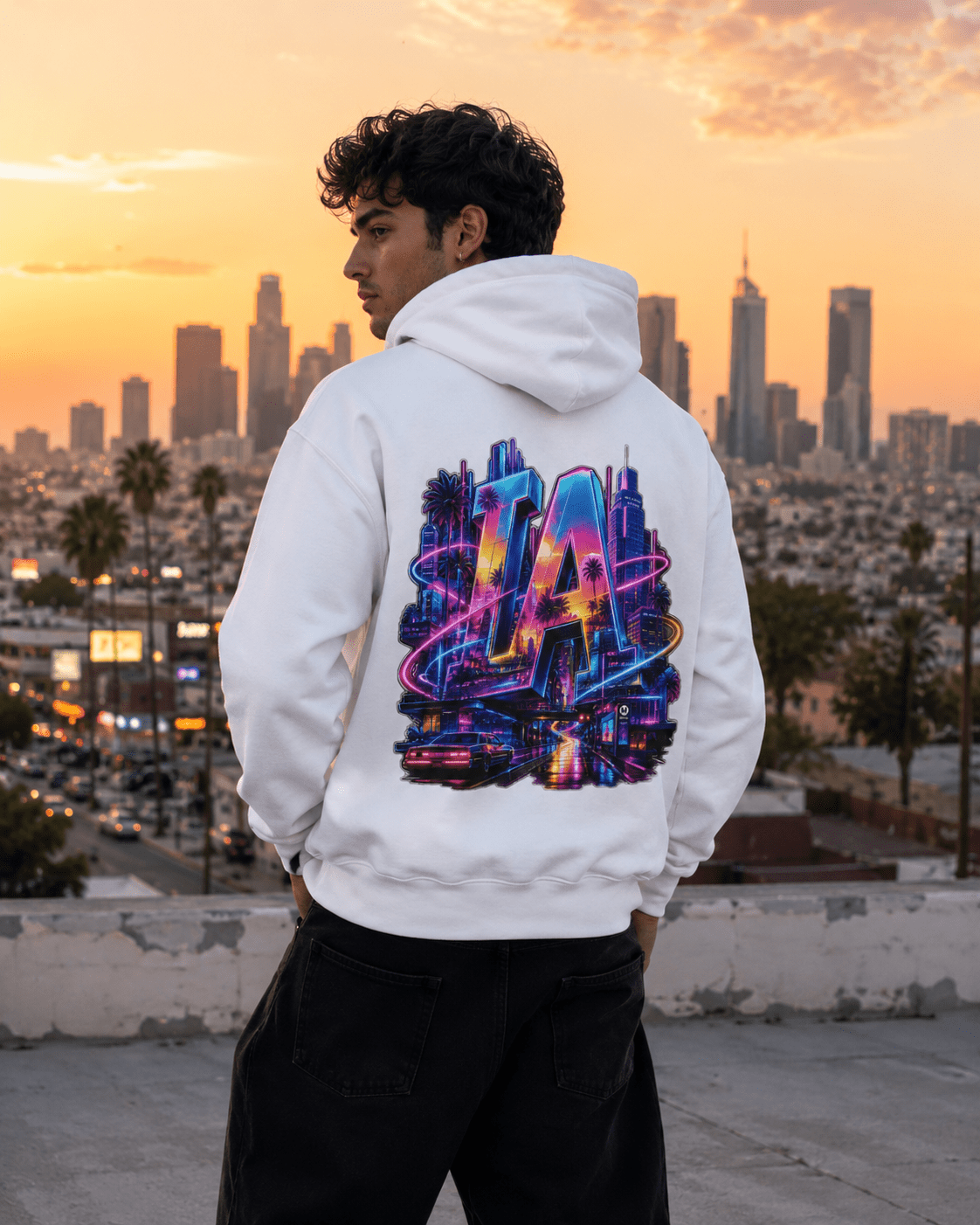 White hoodie worn by model, back neon LA city graphic with colorful skyline