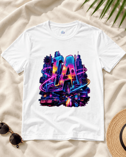 White T-shirt with neon LA graphic, flat lay on light fabric with accessories