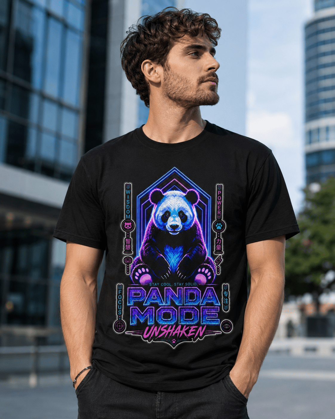 A man wearing a black graphic t-shirt with a colorful neon panda design and the text 'PANDA MODE UNSHAKEN'. The background is a blurred outdoor city scene with modern glass buildings.