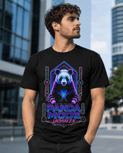 A man wearing a black graphic t-shirt with a colorful neon panda design and the text 'PANDA MODE UNSHAKEN'. The background is a blurred outdoor city scene with modern glass buildings.