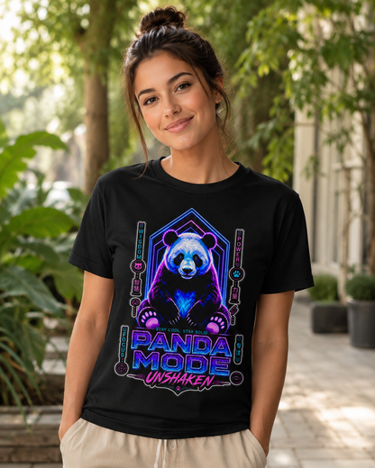 A woman wearing a black graphic t-shirt with a neon purple and blue panda design, standing in an outdoor garden setting.
