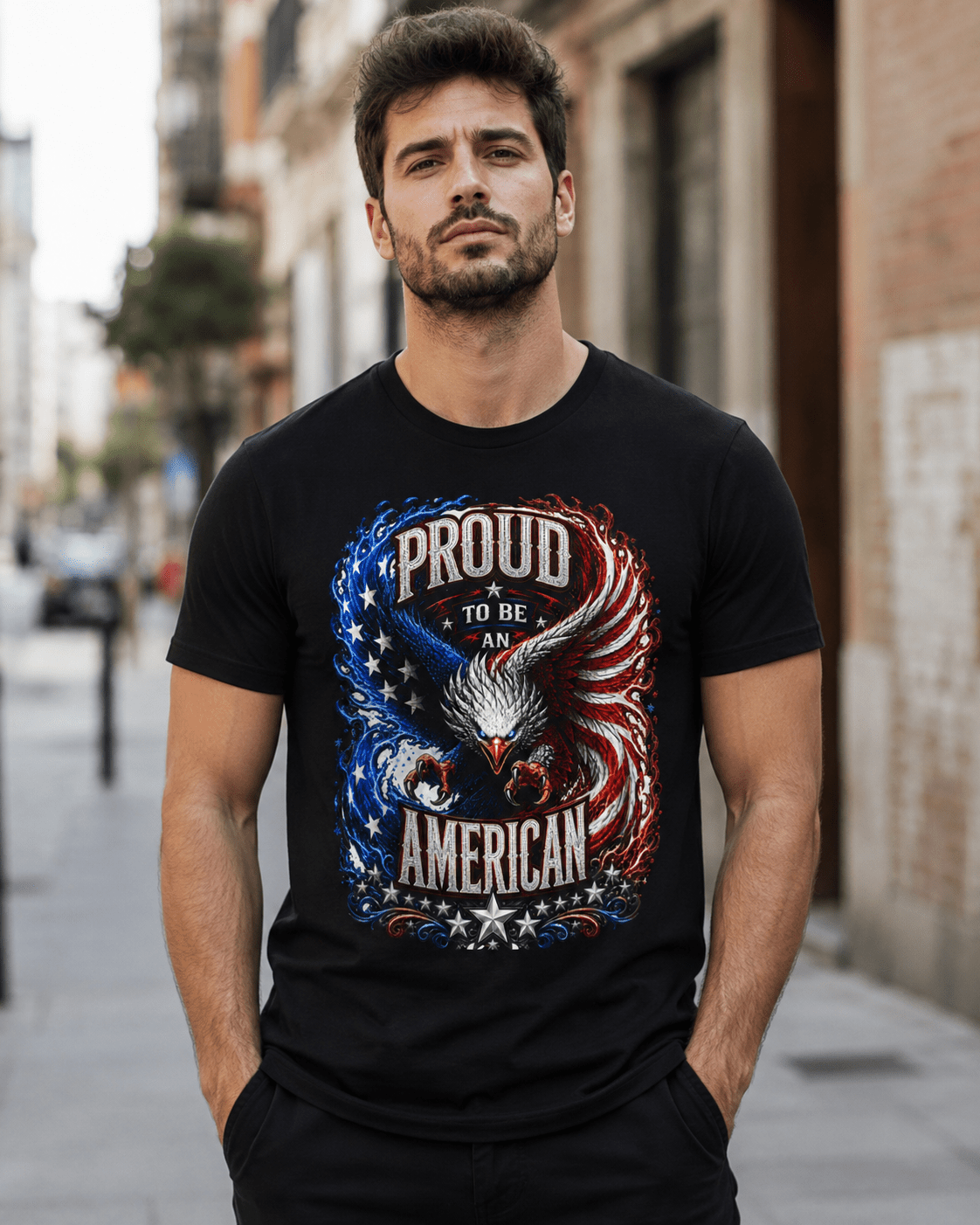 A man wearing a black t-shirt with a patriotic graphic that reads 'PROUD TO BE AN AMERICAN' featuring an eagle and stars, standing on a city street.