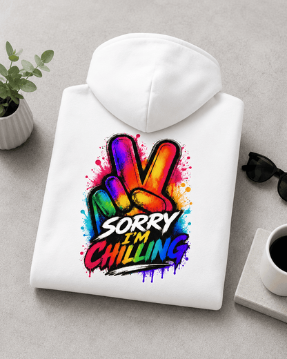 Folded white hoodie with Sorry I'm Chilling colorful back graphic and hood