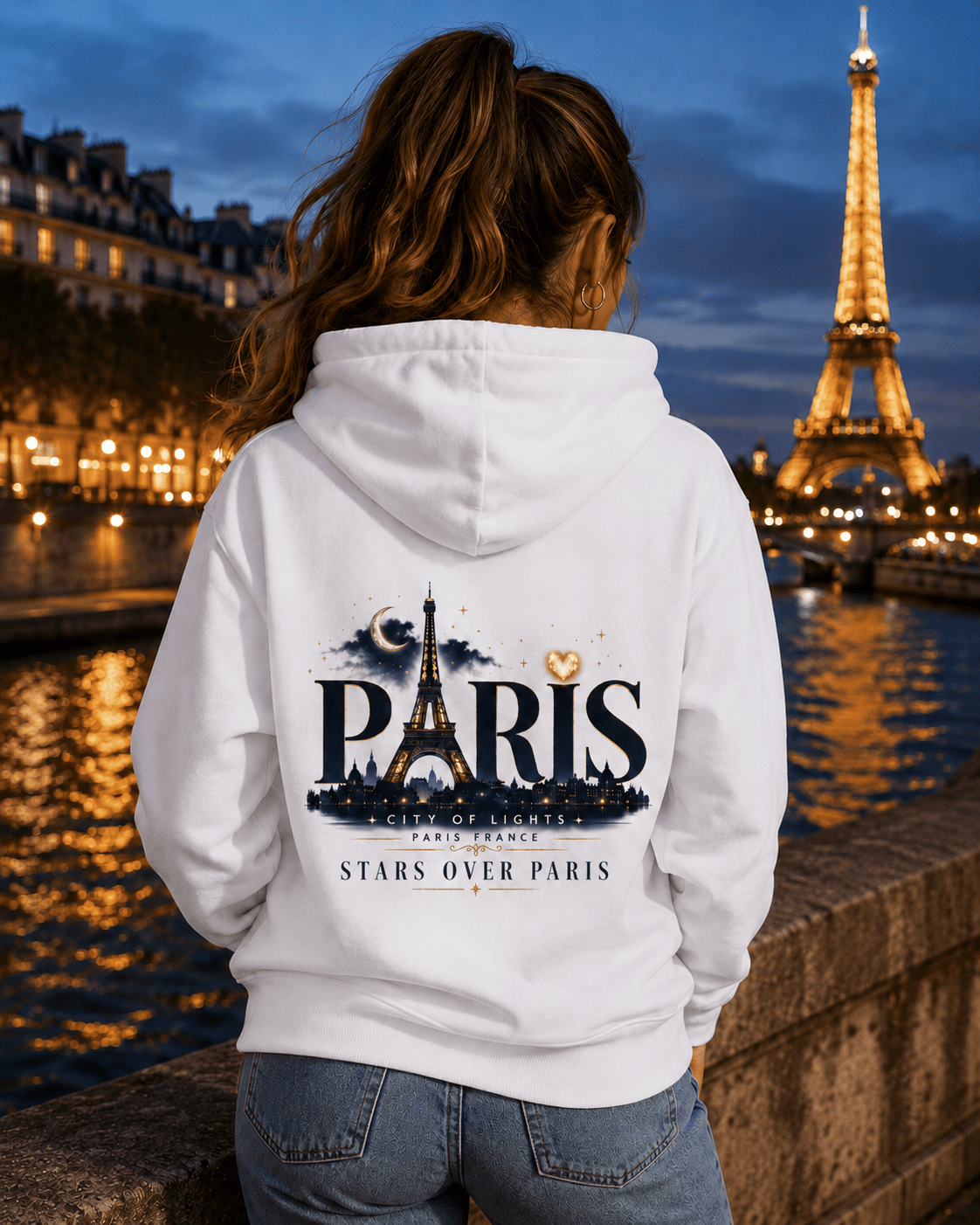 White hoodie back print showing Paris skyline, stars, and Eiffel Tower