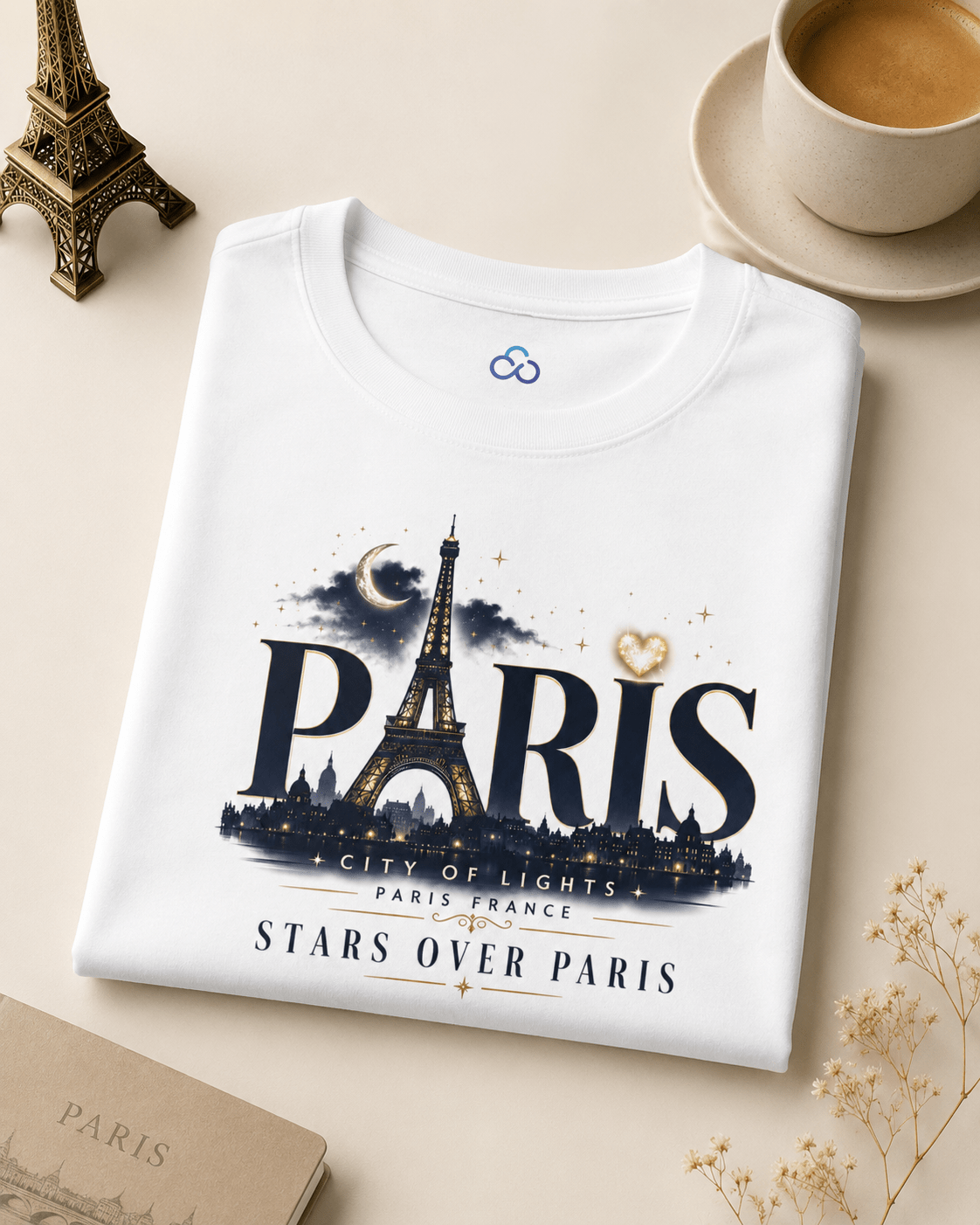 Folded white T-shirt with large Paris Eiffel Tower graphic and stars over Paris print