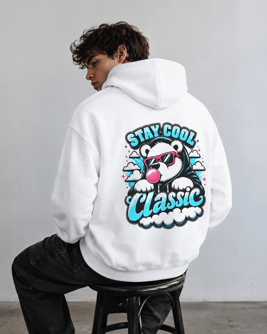 White hoodie with bear graphic and 'Stay Cool Classic' text on back, standing