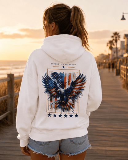 White hoodie worn outdoors, back eagle and stars graphic visible behind the hood