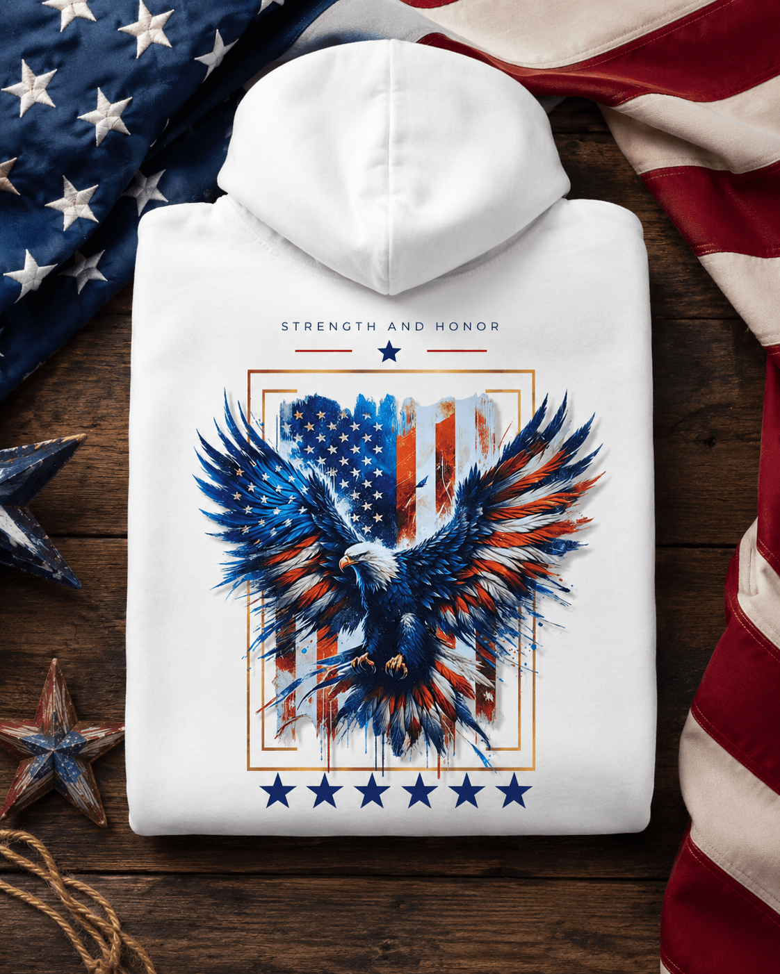 White hoodie folded, eagle and stars graphic centered on the back with hood on top