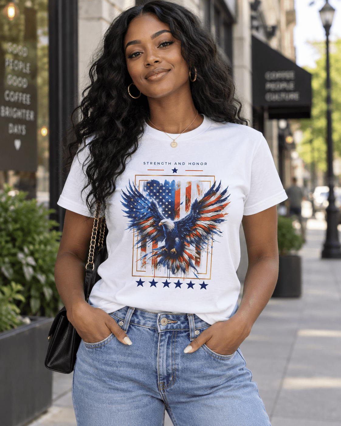 White T-shirt on model showing blue-red eagle artwork and star row at the bottom.