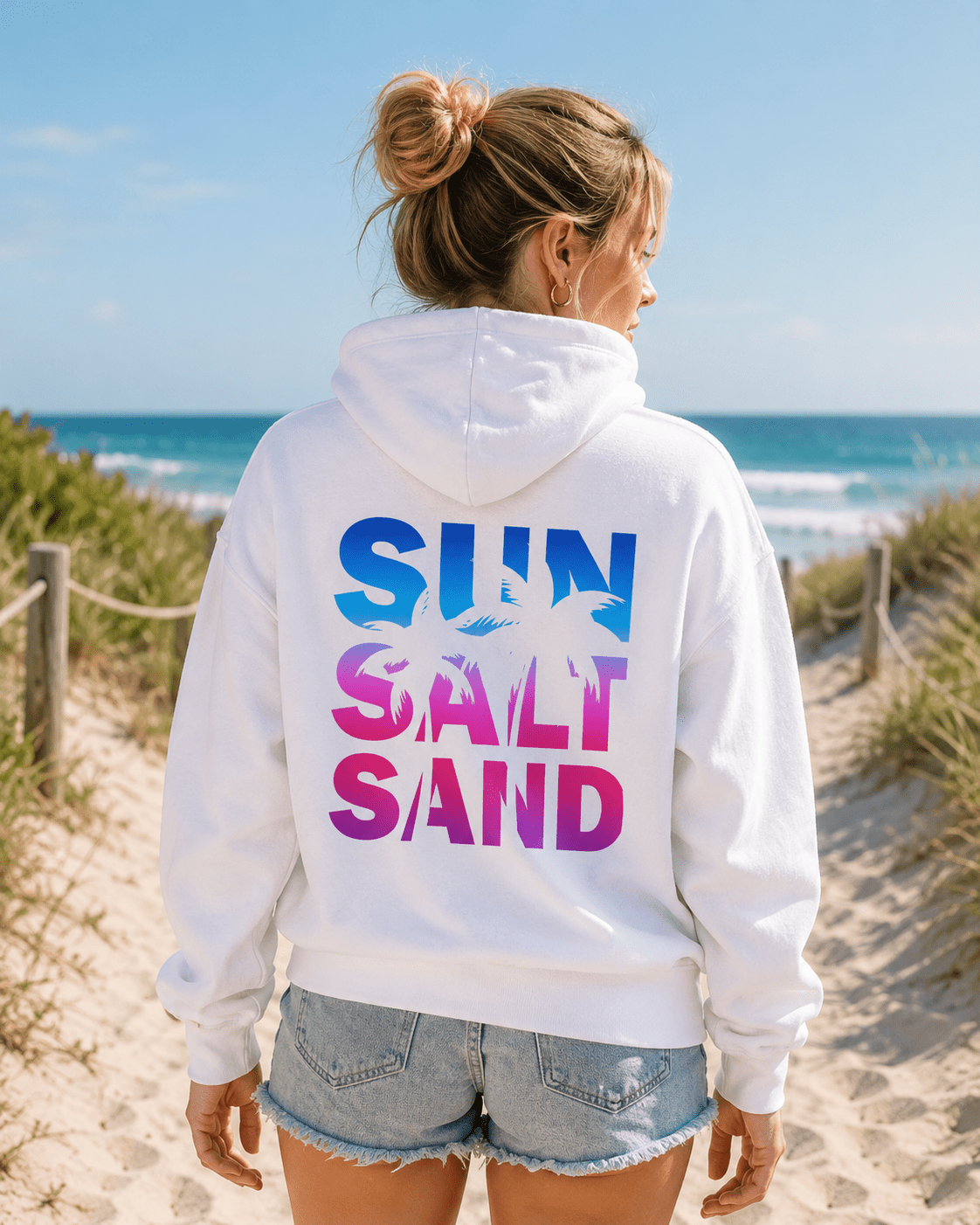 White hoodie with 'SUN SALT SAND' back graphic, worn outdoors