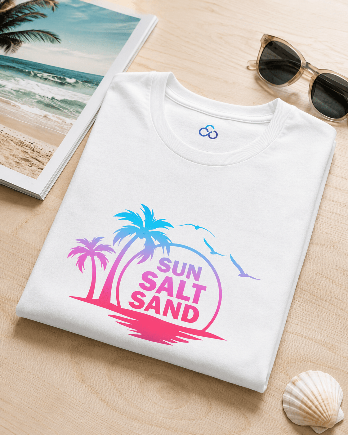 White folded Sun Salt Sand T-shirt with colorful palm island and wave graphic