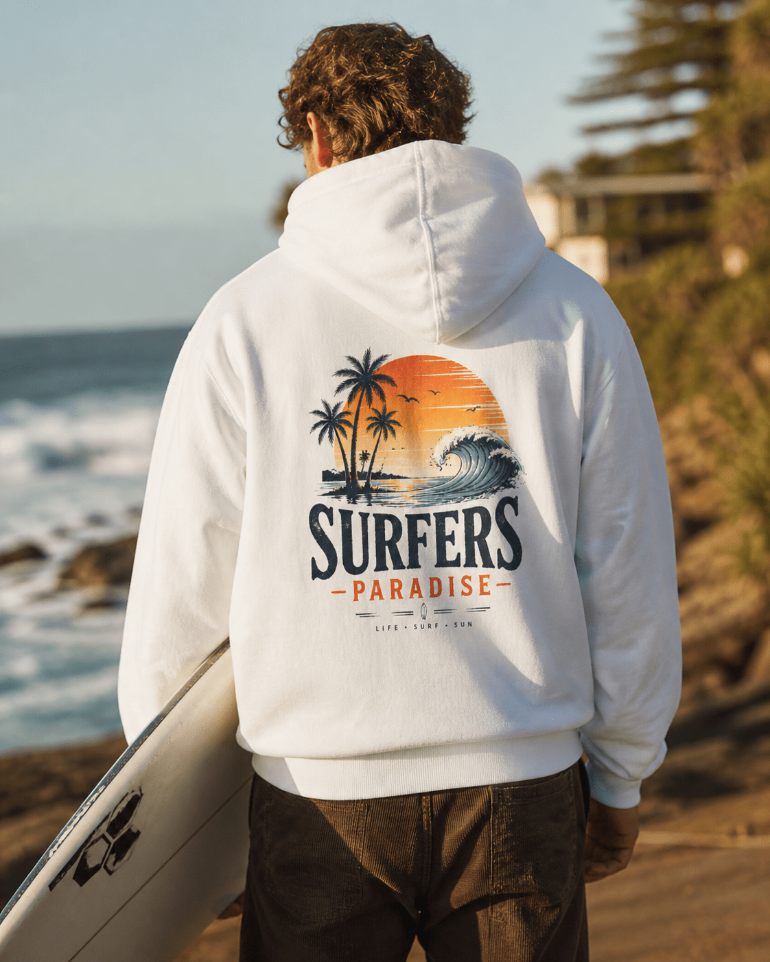 White pullover hoodie on person, hood up; surf-themed back graphic with palms and wave