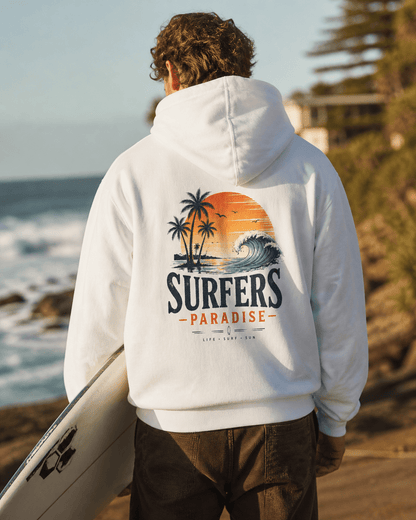 White pullover hoodie on person, hood up; surf-themed back graphic with palms and wave