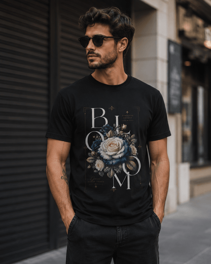 Man wearing a black t-shirt with floral design and 'BLOOM' text on a city street.