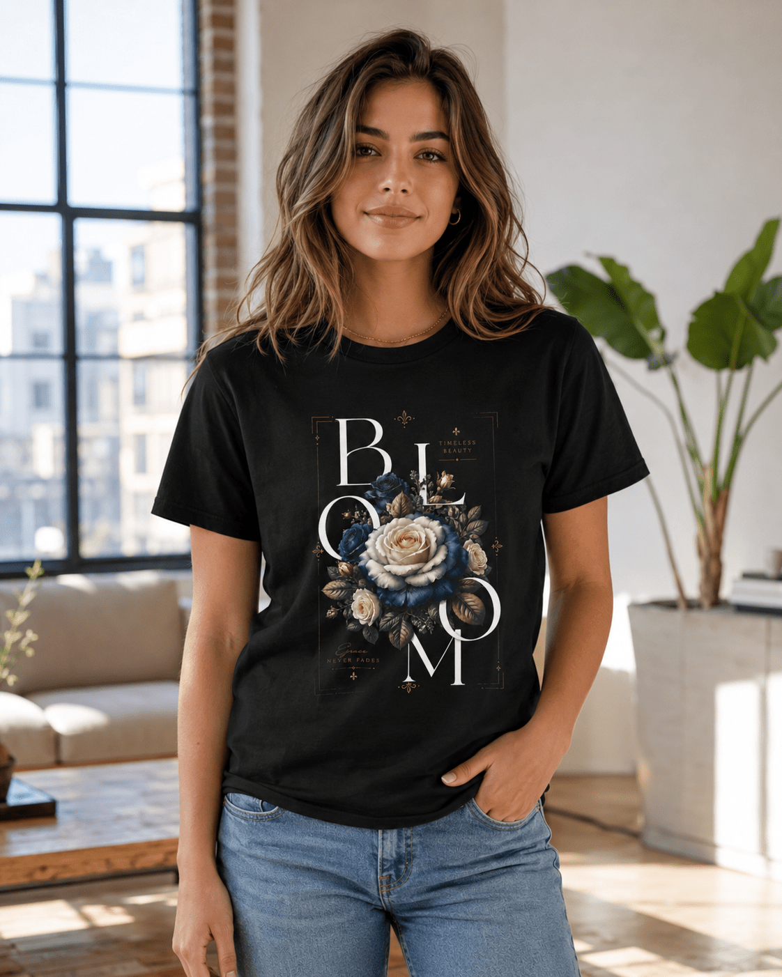 Woman wearing a black t-shirt with floral design and 'BLOOM' text in a living room.