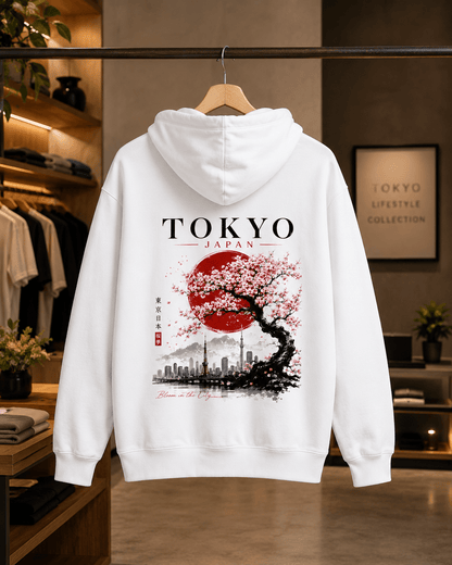 White hoodie, hooded back view, TOKYO text above cherry tree skyline graphic.