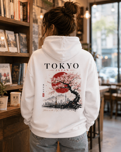 White hoodie worn with back TOKYO JAPAN cherry tree skyline print; hood down.