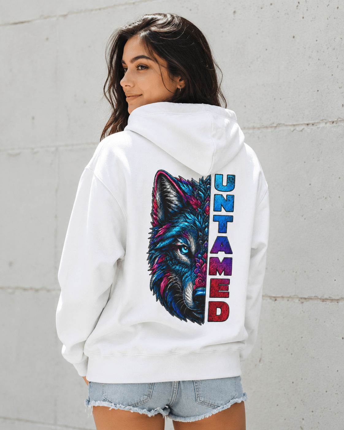 White pullover hoodie on model, wolf graphic with vertical UNTAMED print