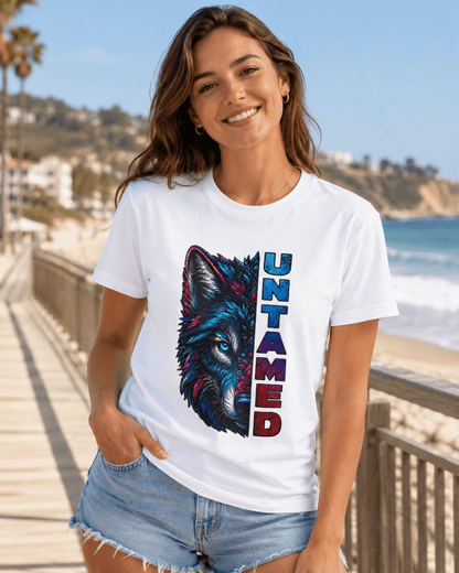 White Untamed T-shirt on a smiling woman with colorful wolf graphic and vertical 'UNTAMED' text