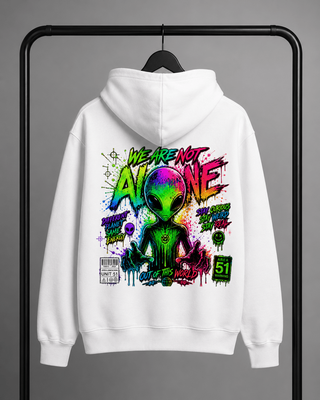 White hoodie on hanger with colorful alien graphic centered on the back