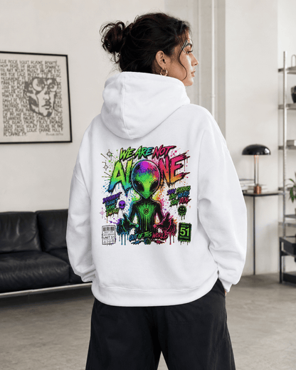 White hoodie worn from behind indoors, with colorful alien graphic on the back