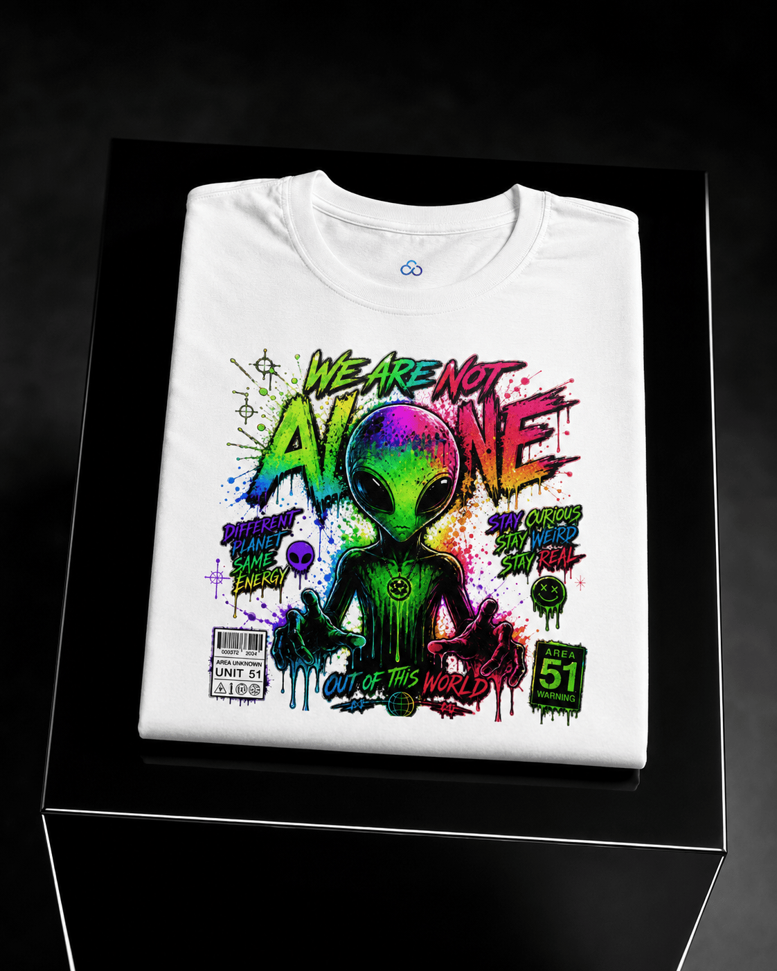 Folded white graphic T-shirt with alien head and neon front artwork